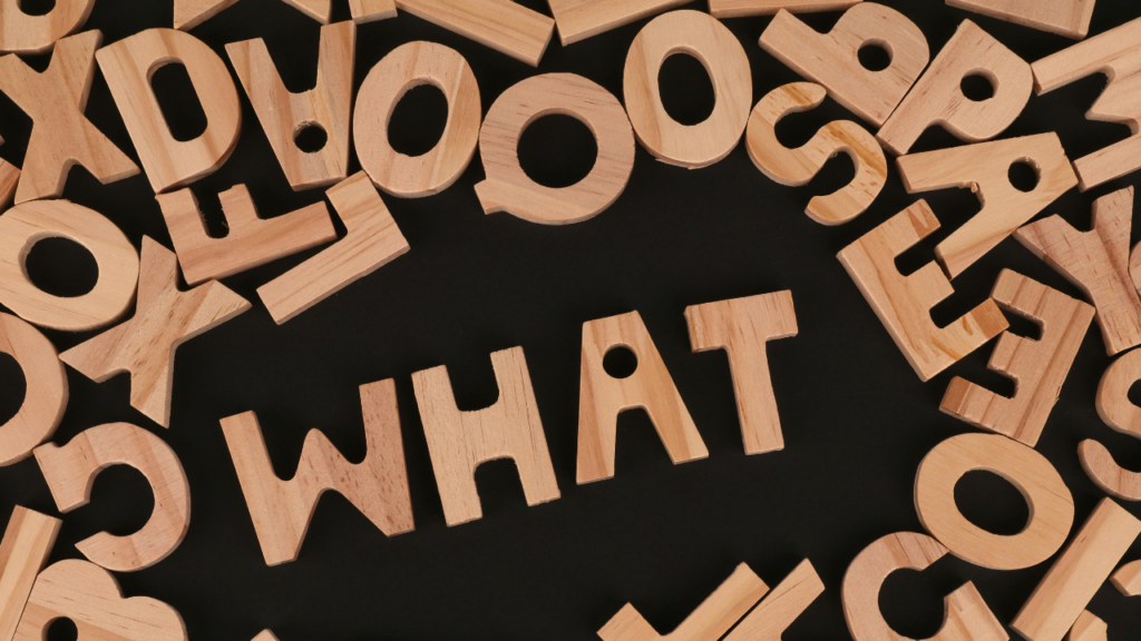 アルファベット型のブロックを並べてWHATと書かれている